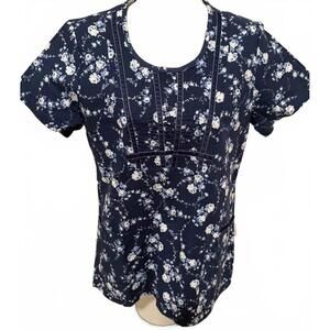WHITE CROSS WOMENS SIZE XSMALL SCRUB TOP BLUE WITH WHITE FLOWERS NEW WITH TAGS